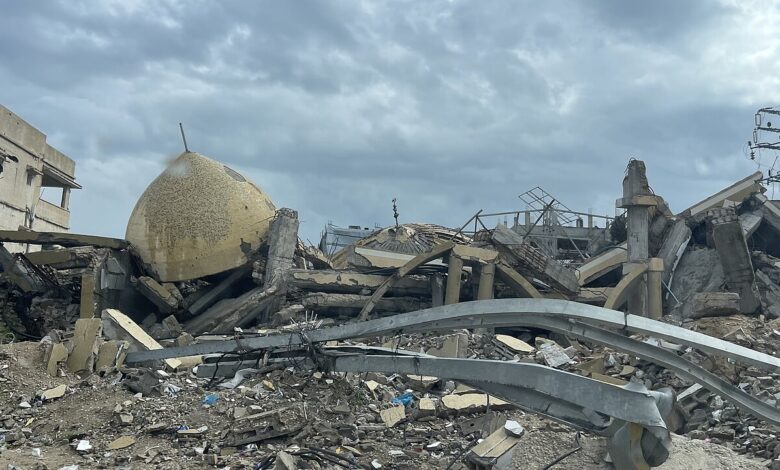 Collapsed mosque dome and surrounding concrete rubble under a cloudy sky in the Jabalia area of the Gaza Strip; damaged structures and twisted metal are visible across the scene.